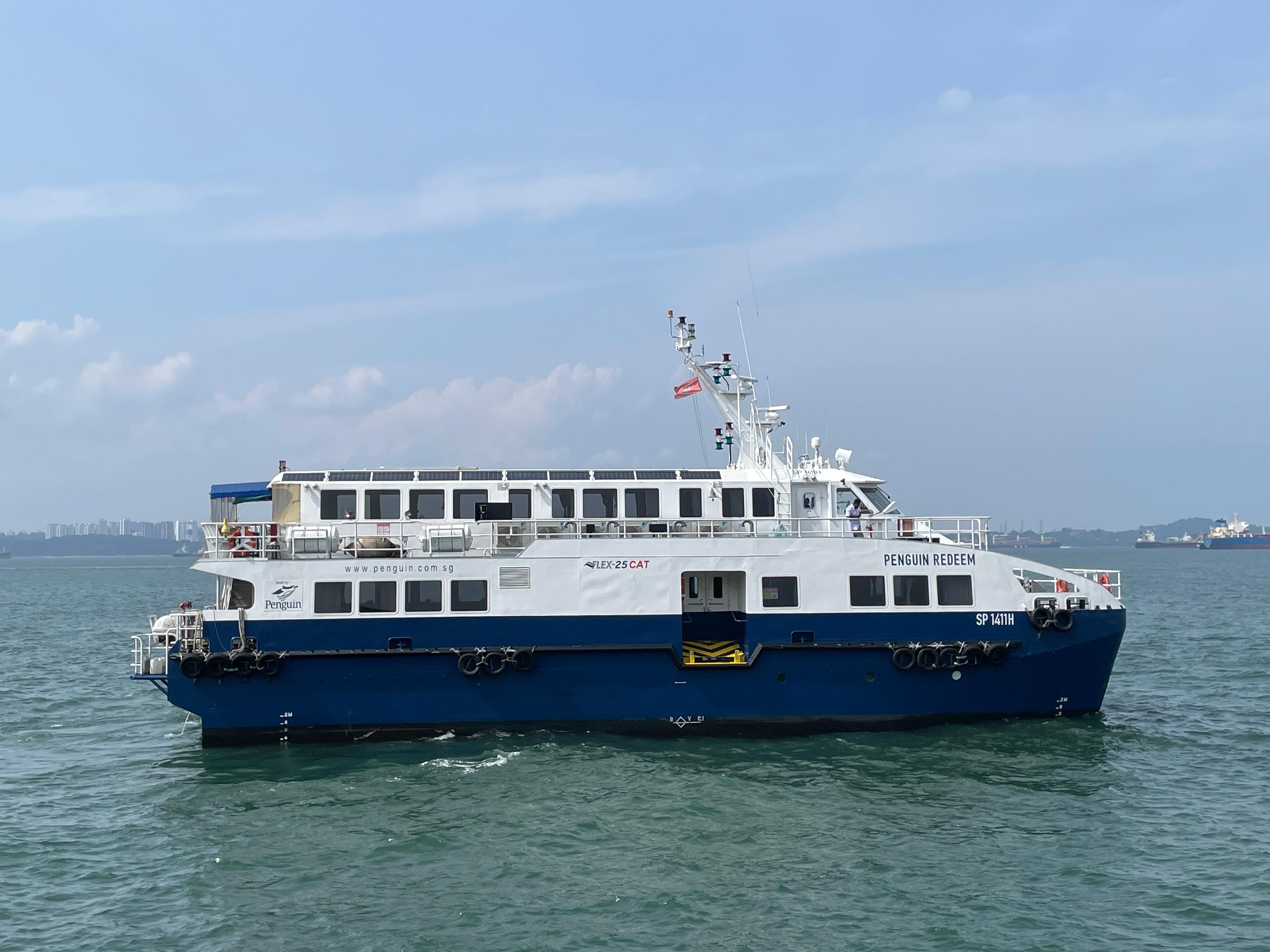 A white and blue ferry in the sea