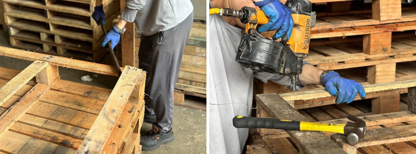 Person holding a crowbar to dislodge a pallet. Person using a tool on a pallet.