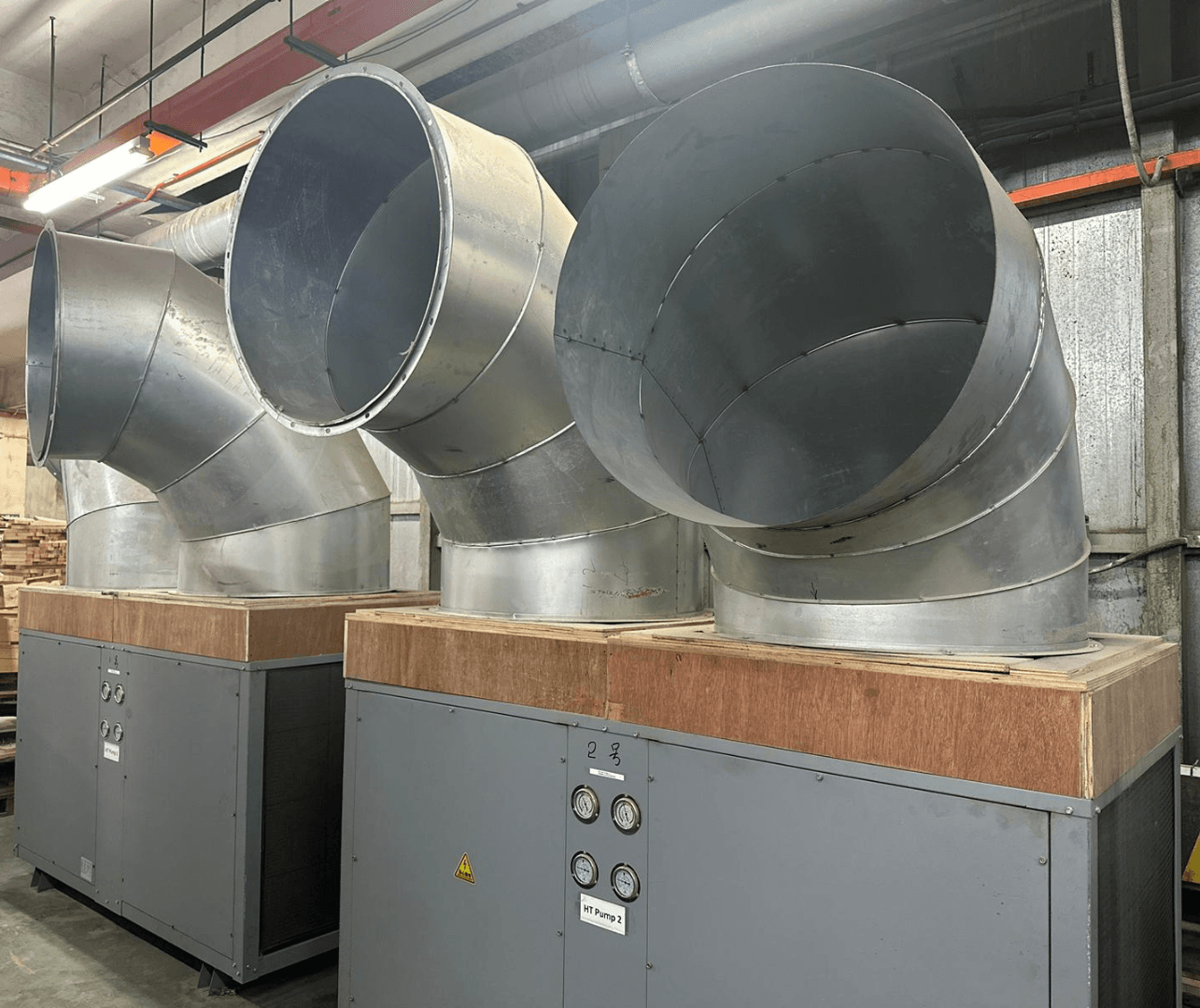 two machines side by side, each with two large hollow tube sticking out